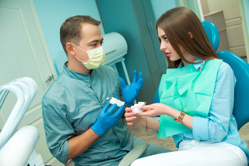 Dentist talking to patient about dental implants and restorations