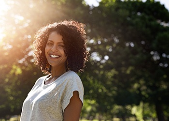 a woman smiling in a park