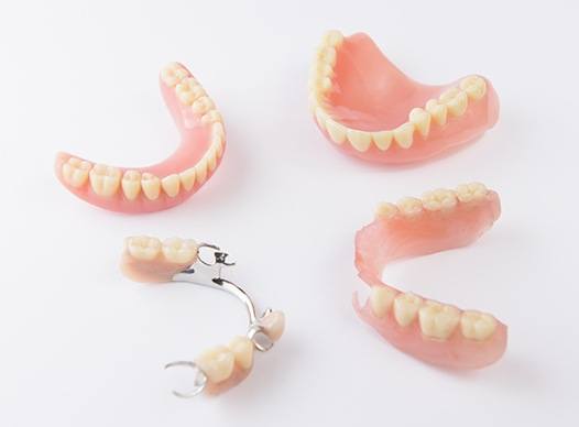 four examples of dentures and partials