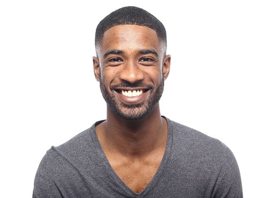 Man with an attractive smile after full mouth reconstruction.
